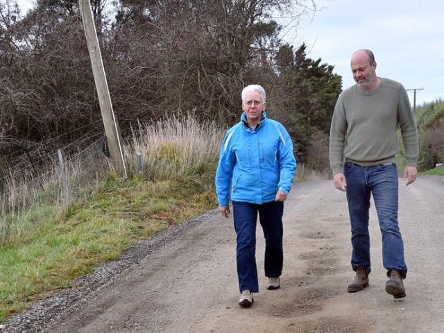 McMaster Rd residents Julie Pearse and Dr Ohad Dar would like to see the troublesome road sealed....