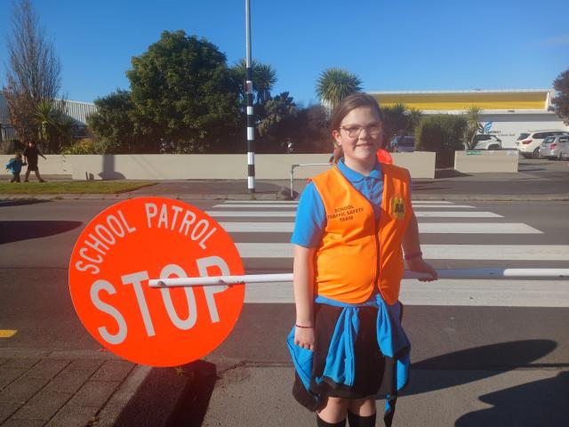 Waitākiri School Patrol member Zoe Simpson, 10, helps pupils, parents and caregivers cross safely...