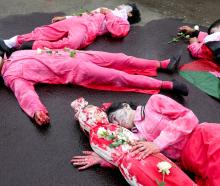 Activists stage a theatrical show during a protest against Israel and in support of Palestinians...