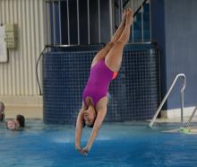 Katrina Bryant in mid-dive during a training session at Moana Pool this week. PHOTO: STEPHEN...