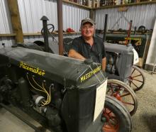 Tractor collector Anthony Hampton stands beside his prized 1936 Massey Harris Pacemaker and a...