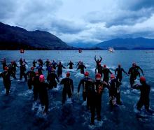 Competitors enter the lake for the start of  Challenge Wanaka on Saturday. Photos: Getty Images