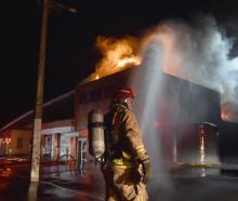 Firefighters tackle a large fire at the former Wolfenden and Russell building in South Dunedin in...