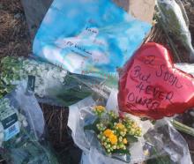 Flowers left at the scene of the crash near Timaru last August. Photo: RNZ 