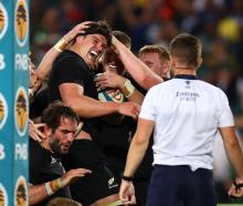 Scott Barrett celebrates with teammates after scoring the All Blacks' fourth try against South...