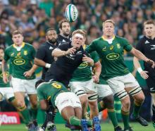 All Blacks captain Sam Cane is hit in a tackle during the match against South Africa. Photo:...