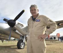 Pilot Steve Hinton, of the United States, stands in front of a newly restored Mosquito de...