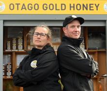 Otago Gold Honey owners Carlee McCaw and Tom Sinclair stand in front of their honey stall...