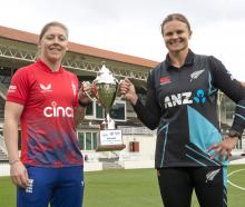 England captain Heather Knight (left) and White Ferns captain Suzie Bates with the trophy ahead...