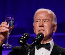 US President Joe Biden raises a toast during the White House Correspondents' Association Dinner...
