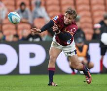 Highlanders halfback James Arscott sends out a pass during the game against the Chiefs in...