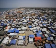 Thousands of Palestinians have begun to flee Rafah, many setting up makeshift tent camps in the...