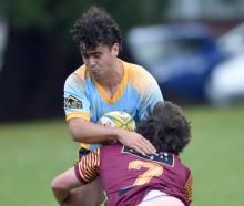 University hooker Oliver Hatch carries the ball as he is tackled by AU flanker McKenzie Hunter at...