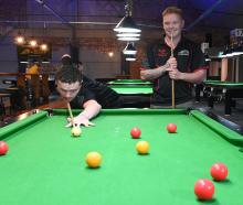 Jackson Wright (left) plays a shot while Blane Watson watches on at Bowey’s Pool Lounge in...