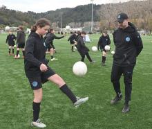 Dunedin City Royals Academy director-coach Blair Scoullar watches Charlotte Evans, 11, as she...