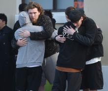 Young people support each other at the Dunedin bus hub yesterday, as a large group gathered for a...