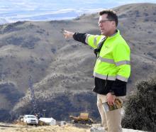 Santana Minerals Ltd chief executive Damian Spring motions towards the Central Otago landscape...
