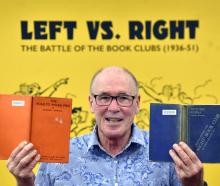 Dunedin Public Libraries heritage collections librarian Donald Kerr holds books from the Left...