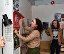 Spaceland co-owners Jenny Duncan and Andrew Frost begin take down posters from their music...