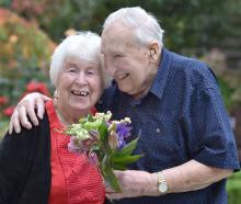 Jack Stanley, 87, gives his wife Joan, 86, flowers (without a paper bag) to celebrate their 65th...