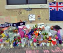 A small sign amidst the memorial messages and flowers at the bus hub, in memory of Enere McLaren...