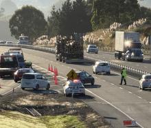 Police direct traffic at the Fairfield on-ramp following a crash this morning. Photo: Craig Baxter