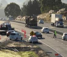 Police direct traffic at the Fairfield on-ramp following a crash yesterday morning. Photo: Craig...