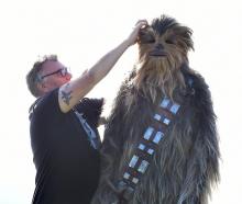 Macandrew Bay Star Wars megafan Jason Connolly adjusts the fur on his Chewbacca costume worn by...