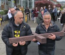 Pesamino Tili (left) and Frank Liman carry the cross from the Mosgiel Presbyterian Church&nbsp...