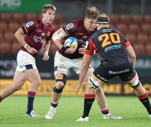 Fabian Holland of the Highlanders braces for the tackle during their match against the Chiefs in...