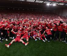 Liverpool players celebrating after being named champions of the Premier League at Anfield after...