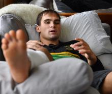 Green Island rugby player Ronan Dynes has his feet up as he recovers at home with a broken leg....