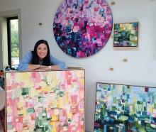 Jane Shriffer standing among her colourful artwork in her Wānaka studio.PHOTO: OLIVIA CALDWELL