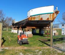 The scow being restored on the Kaiapoi River bank. Photo: Kaipuke Kaiapoi Charitable Trust