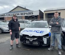 Mark Jones Collision Repairs owners Adam Cassidy and Jason Donaldson with a police car that is in...