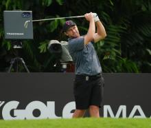 Ben Campbell reacts after a tee shot during the LIV Golf event at the Sentosa Golf Club in...