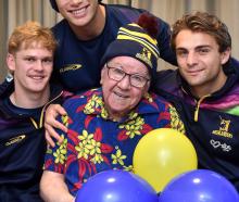 Highlanders (from left) Finn Hurley, Thomas Umaga-Jensen and James Arscott visit superfan Dennis...