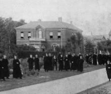 Priests and students gather outside Holy Cross College, a Catholic theological seminary in...