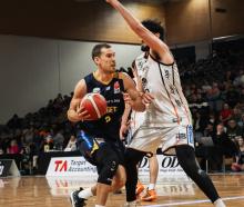 Otago Nuggets forward Jono Janssen drives at Hawke's Bay Hawks big Luca Yates at the Edgar Centre...