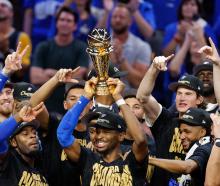 Oklahoma City Thunder players celebrate as Shai Gilgeous-Alexander lifts the Larry O'Brien...