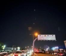 Interceptor missiles are seen in the sky after Iran's armed forces say they targeted the Al-Udeid...