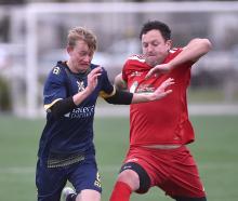 Otago University’s Blake Allison (left) battles for the ball with Northern Hearts’ Bradley...