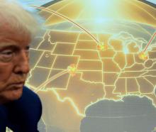 US President Donald Trump speaks in front of a map of Trump's proposed Golden Dome missile...