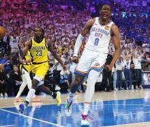 Oklahoma City Thunder's Jalen Williams celebrates a slam dunk as Indiana Pacers guard Aaron...