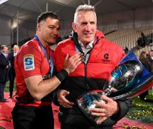 David Havili of the Crusaders and head coach Rob Penney celebrate after winning the Super Rugby...