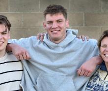 New All Black Fabian Holland (centre) with brother Quinten and mum Margot at the Dunedin Rugby...