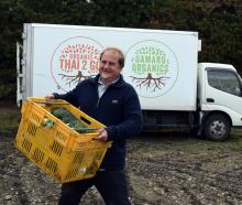 Organic Solutions director and co-founder James Porteous packs a truck with organic vegetables in...