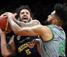 Otago Nuggets small forward Jose Perez tries to bulldoze his way through Manawatū Jets player...