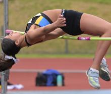 Libby Norfield (HCU) clears the bar during the high jump competition. 