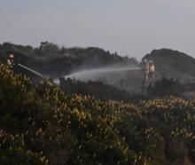 Firefighters fight a vegetation fire at Tomahawk Lagoon, thought to have been started by...